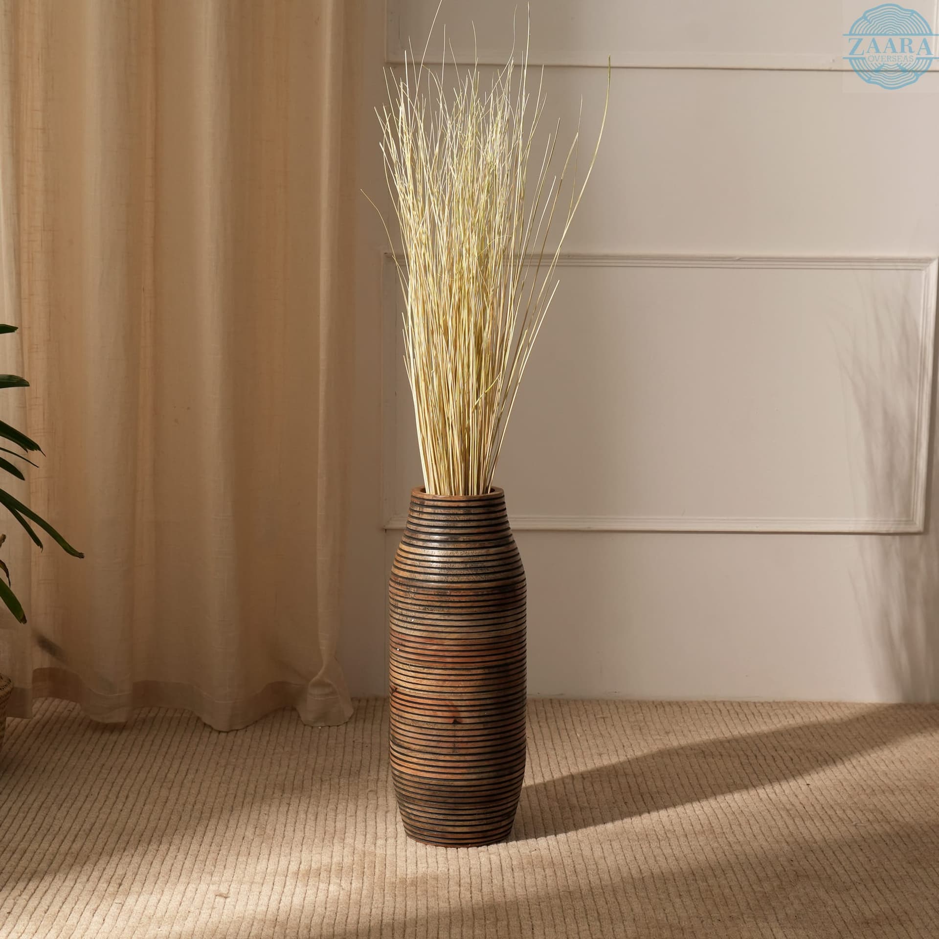 Handcrafted wooden vase with dried stems, styled in a warm modern Indian home